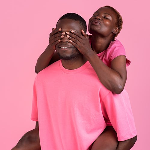 side-view-couple-posing-with-pink-outfit