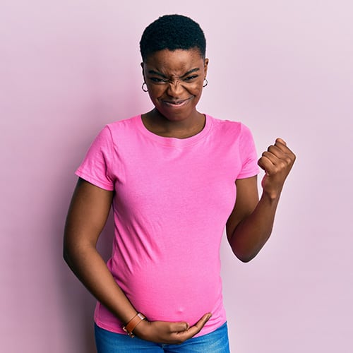 young-african-american-woman-expecting-baby-touching-pregnant-belly-very-happy-excited-doing-winner-gesture-with-arms-raised-smiling-screaming-success-celebration-concept